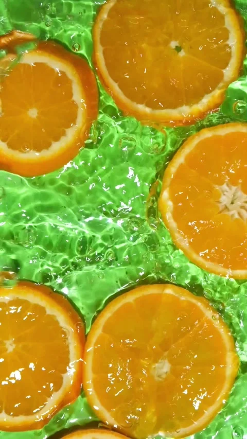 Abstract clean water ripples moving across organic orange slices, overhead view Stock Footage 339620883