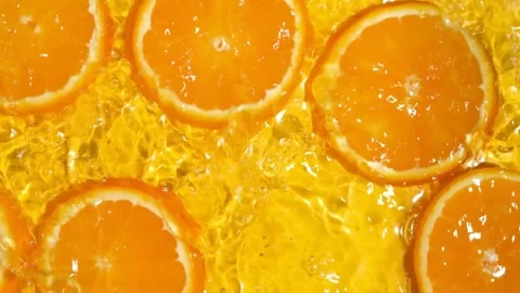 Abstract clean water ripples moving across organic orange slices, overhead view. Stock Footage 339620909