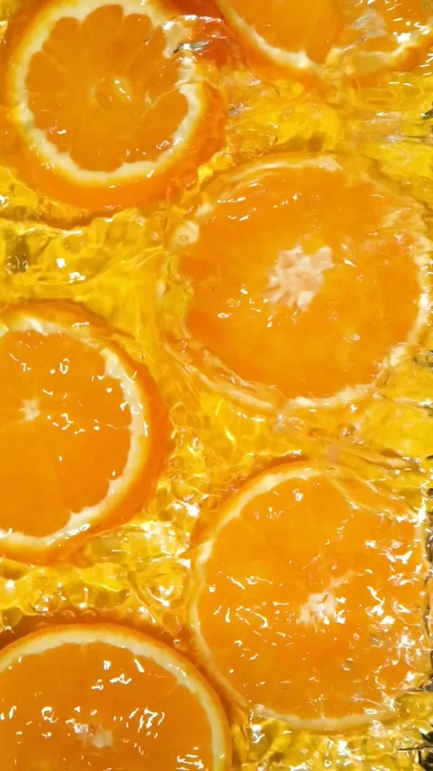 Abstract clean water ripples moving across organic orange slices, overhead view. Stock Footage 340168094