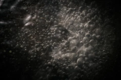 Abstract close-up of blurred bubbles and textures on a dark background, cre.. Stock Photos