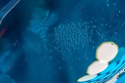 Abstract close-up of bubbles in blue liquid.  Intriguing texture and color .. Stock Photos
