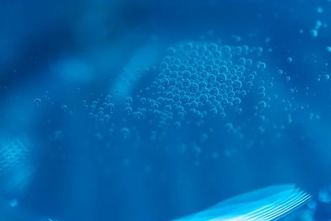 Abstract close-up of bubbles in blue liquid.  A mesmerizing texture of air .. Stock Photos