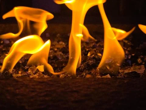 Abstract Close-Up of Dancing Orange Fire Flames on Decorative Fire Glass in.. Stock Photos