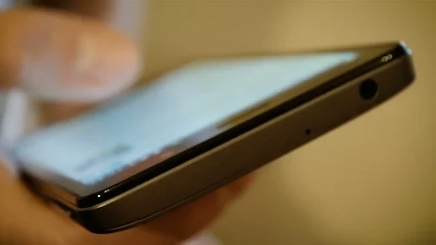 Abstract Close-Up Male Hand Using a Smart Phone at Home Stock Footage 74172577
