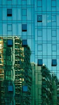 Abstract close up of a modern skyscraper with a blue glass facade reflecting  Stock Photos
