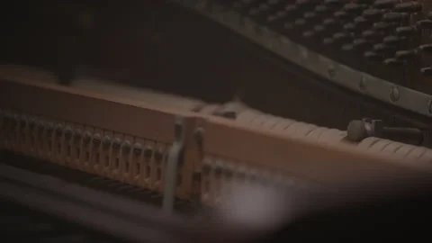 Abstract Close-up of Piano Components Striking Strings in Moving Studio Lighting Stock-Footage 222005654