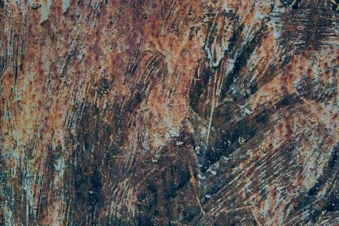 Abstract close-up of rust and aged paint on a corroded metal surface. Stock Photos