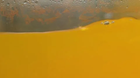 Abstract Close-up of Thick Orange Liquid with Bubbles Stock Footage 331492873