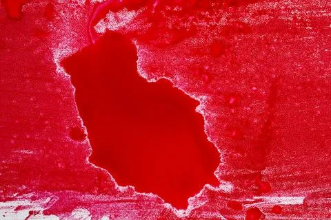 An abstract close-up of vibrant red paint or liquid ink spilled on a textur.. Stock Photos