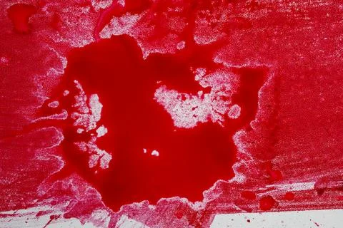 An abstract close-up of vibrant red paint or liquid ink spilled on a textur.. Stock Photos