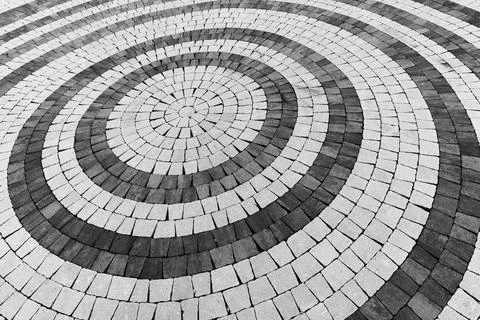 Abstract close-up view of a circular paving pattern, background texture Stock Photos