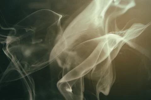 Abstract close-up view of elegant white smoke swirling against a dark backg.. Stock Photos