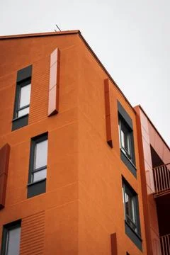 Abstract close-up view of a modern bright orange apartment building corner .. Stock Photos
