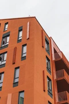 Abstract close-up view of a modern bright orange apartment building corner .. Stock Photos