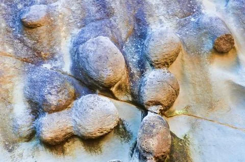 Abstract closeup of colorful eroded texture on the beach Stock Photos