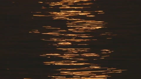 Abstract closeup of sunrise reflection on water/lake Stock Footage 139780933