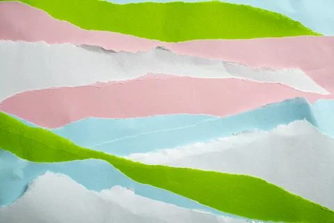 An abstract collage background featuring overlapping layers of torn colored.. Stock Photos