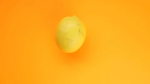 Abstract color animation of moving lemon on orange background Stock Footage 128896590