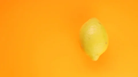 Abstract color animation of moving lemon on orange background Stock Footage 128896632