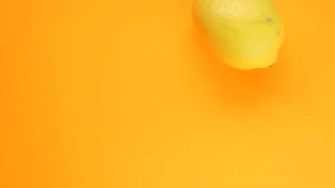 Abstract color animation of moving lemon on orange background Stock Footage 128896829