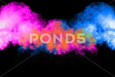 Abstract color powder explosion on black background. Stock Photos