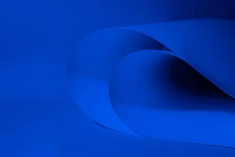 Abstract colored background, created with curved blue paper sheets. Stock Photos