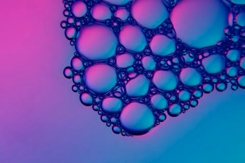 Abstract colored background, soap bubbles on the water surface. Micro texture Stock Photos