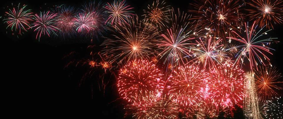 Abstract colored firework on dark sky. Celebration and anniversary concept... Stockfoto's