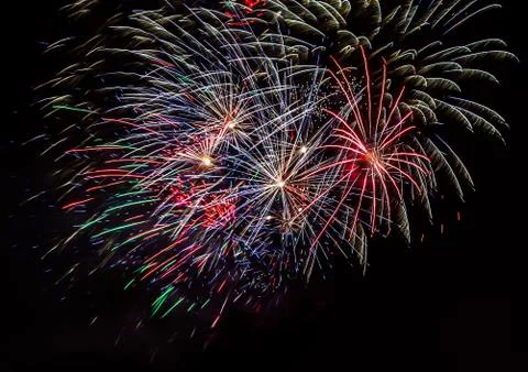 Abstract colored firework explode at the black background, with free space fo Stock Photos