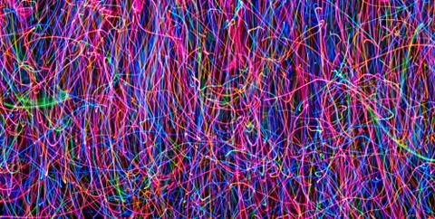 Abstract colored light lines on a black background. Blue, green, orange, pink Stock Illustration