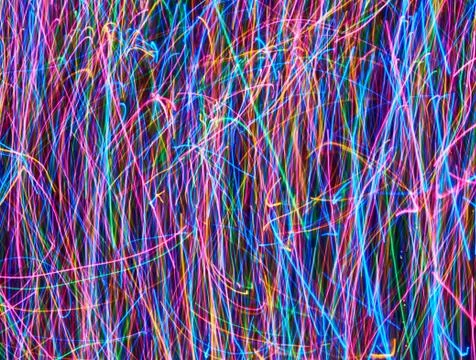 Abstract colored light lines on a black background. Foto stock