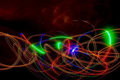 Abstract colored lines on a dark background. Stock Photos
