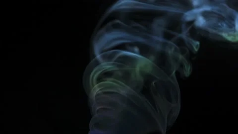 Abstract colored smoke rises up in beautiful swirls on a black background. Stock Footage 208395670
