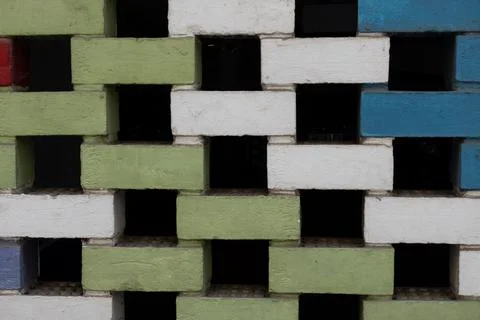 Abstract colorful brick wall with an openwork geometric pattern of painted .. Stock Photos