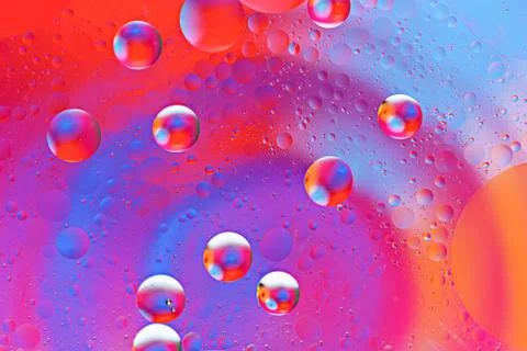Abstract colorful pattern of bubbles from oil drops on water surface Stock Photos