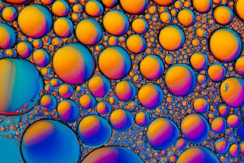 Abstract of coloured bubble patterns formed by oil floating on water. Ai-generat Illustrazione stock
