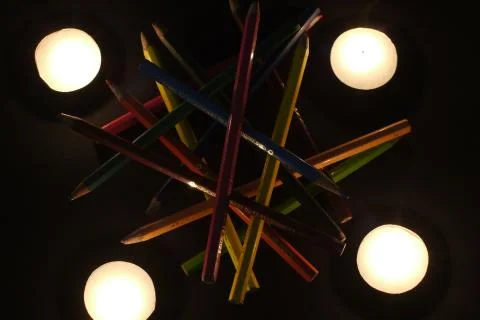 Abstract composition of colored pencils and candles Stock Photos