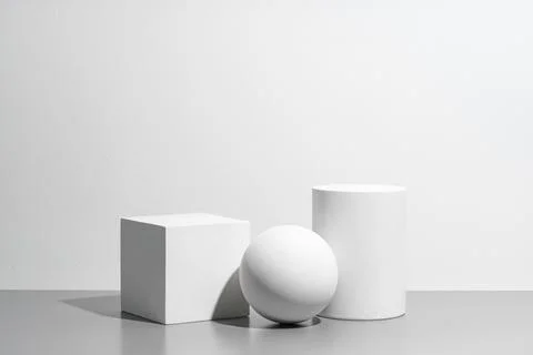 Abstract composition featuring three white geometric shapes in a minimalist Stock Photos