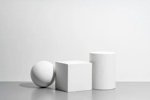 Abstract composition featuring three white geometric shapes in a minimalist Stock Photos