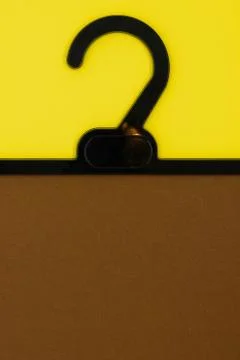 Abstract composition of plastic black hanger split yellow and brown color bac Stock Photos