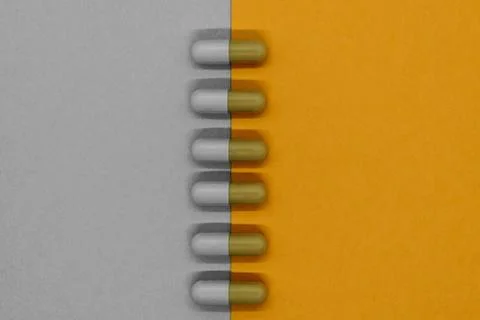 Abstract composition of separated in grey and orange colors medication pills Foto stock