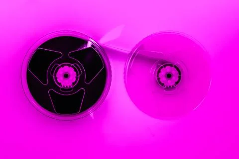 Abstract composition of video home system VHS tape reels in pink color effect Stock-Fotos
