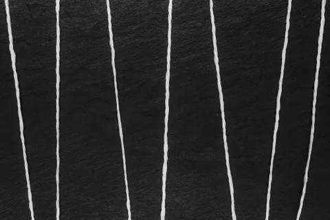 Abstract composition of white thread on black stone background surface Stock Photos