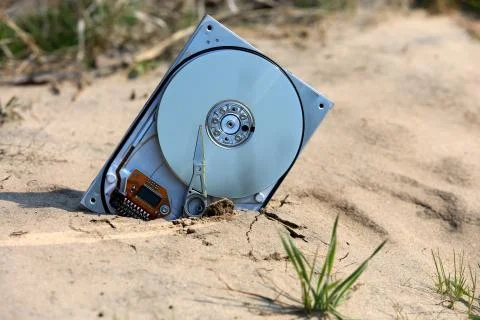 Abstract computer hard drive in the sand Stock Photos