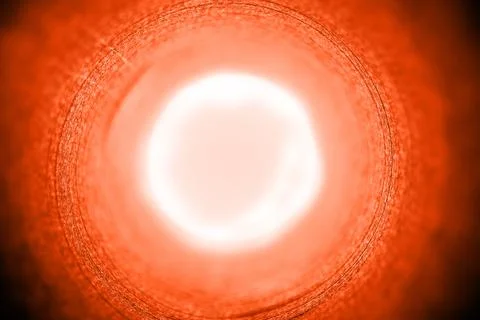 Abstract concentric background pattern in bright orange color with a sun halo in Stock Photos