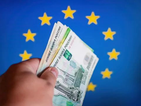 Abstract concept idea: 2000 ruble banknote in a hand in front of symbolic blu Stock Photos