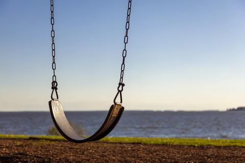 Abstract concept showing close up   empty swing seat with the chains overlook Stock Photos