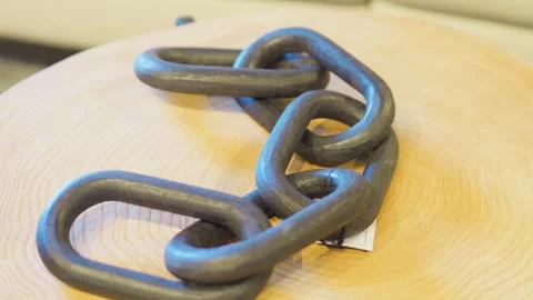 Abstract concept of unity with wooden chain links on log table Stock Footage 339039222