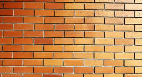 Abstract copy space seamless background texture red-brown solid brick wall. Stockfoto's