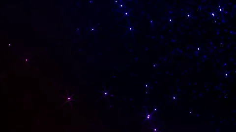 Abstract cosmic particles flowing in deep space. Glowing blue dots and stars mov 库存影片 340450378